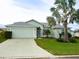 Single-Gathering home with light green exterior and palm trees at 6064 Condor Dr, Lakeland, FL 33809