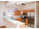 Kitchen features light wood cabinets, stainless steel appliances, and a breakfast bar at 6064 Condor Dr, Lakeland, FL 33809