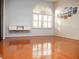 Living room with hardwood floors and a large arched window at 6064 Condor Dr, Lakeland, FL 33809