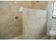 Walk-in shower with beige tile and frameless glass at 6064 Condor Dr, Lakeland, FL 33809