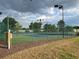 Two well-maintained tennis courts with chain link fence at 6064 Condor Dr, Lakeland, FL 33809