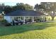 Ranch style home with a large front porch and yard at 6155 Bethlehem Rd, Mulberry, FL 33860
