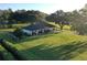 White house with dark roof, large yard, and trees at 6155 Bethlehem Rd, Mulberry, FL 33860