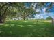 Open farmland with a home in the distance under a bright blue sky at 6155 Bethlehem Rd, Mulberry, FL 33860