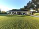 White house with a spacious front yard and long driveway at 6155 Bethlehem Rd, Mulberry, FL 33860