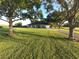 White house with a spacious front yard and long driveway at 6155 Bethlehem Rd, Mulberry, FL 33860