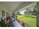 Covered porch with wooden bench, overlooking the property at 6155 Bethlehem Rd, Mulberry, FL 33860