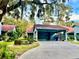 Front view of a condo with carport and well-manicured landscaping at 6718 Trail Ridge Dr, Lakeland, FL 33813
