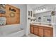 Bathroom with double vanity, soaking tub and decorative wall at 6799 Glenbrook Dr, Lakeland, FL 33811
