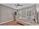Bright bedroom with wood floors, window shutters, and a ceiling fan at 6799 Glenbrook Dr, Lakeland, FL 33811
