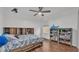 Spacious bedroom with wood floors, built-in shelving, and ceiling fan at 6799 Glenbrook Dr, Lakeland, FL 33811