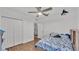 Bedroom with wood floors, double doors, and ceiling fan at 6799 Glenbrook Dr, Lakeland, FL 33811