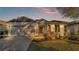 Charming one-story house with gray and beige exterior, landscaping, and a two-car garage at 6799 Glenbrook Dr, Lakeland, FL 33811
