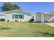 White single story home with carport and green lawn at 718 Barber Cir # 718, Lakeland, FL 33803