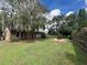Large grassy backyard with firepit and seating at 737 Butternut Pl, Lakeland, FL 33813