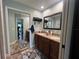Double vanity bathroom with granite countertop and large mirror at 737 Butternut Pl, Lakeland, FL 33813