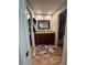 Bathroom features a double vanity, tiled floors and a large mirror at 737 Butternut Pl, Lakeland, FL 33813
