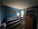 Blue bedroom with a striped bedspread and a built-in workspace at 737 Butternut Pl, Lakeland, FL 33813