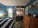 Blue bedroom with a built-in desk and striped bedding at 737 Butternut Pl, Lakeland, FL 33813