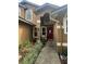 Front entrance with red door, landscaping, and walkway at 737 Butternut Pl, Lakeland, FL 33813
