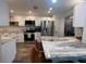 Updated kitchen boasts granite countertops and stainless steel appliances at 737 Butternut Pl, Lakeland, FL 33813