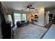 Bright living room with a comfy couch, large rug, and sliding glass doors leading to a patio at 737 Butternut Pl, Lakeland, FL 33813