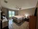 King-size bed, large windows, and wood-look floors in this main bedroom at 737 Butternut Pl, Lakeland, FL 33813