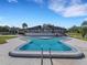 Community pool with a large deck and lake view at 14 Casa Loma Way, Lakeland, FL 33813