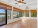 Sunroom boasts lake views, tile floors, and two ceiling fans at 14 Casa Loma Way, Lakeland, FL 33813