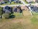 Aerial view of a house with solar panels, a fenced backyard, and a neighborhood setting at 1898 Charleston Ln, Bartow, FL 33830