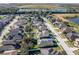 Aerial view showcasing home and surrounding neighborhood near a lake at 1898 Charleston Ln, Bartow, FL 33830