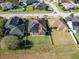 Aerial view of a house with solar panels, a fenced backyard, and a neighborhood setting at 1898 Charleston Ln, Bartow, FL 33830