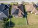 Aerial view of a house with solar panels, a fenced backyard, and a neighborhood setting at 1898 Charleston Ln, Bartow, FL 33830