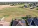 Aerial view showcasing home, fenced backyard and surrounding landscape at 1898 Charleston Ln, Bartow, FL 33830