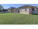 Large backyard with a screened patio and white fence at 1898 Charleston Ln, Bartow, FL 33830