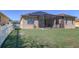 Large backyard with screened patio, solar panels, and white fence at 1898 Charleston Ln, Bartow, FL 33830