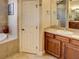 Elegant bathroom with a soaking tub, walk-in shower, and double vanity at 1898 Charleston Ln, Bartow, FL 33830