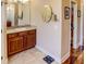 Elegant bathroom with wood cabinets, tile flooring and walk-in shower at 1898 Charleston Ln, Bartow, FL 33830