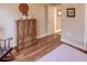 Bedroom with hardwood floors, large dresser and a door to hallway at 1898 Charleston Ln, Bartow, FL 33830
