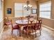 Sunlit dining room with an oval wooden table and six chairs at 1898 Charleston Ln, Bartow, FL 33830