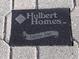 Black plaque with Hulbert Homes logo and Traditional Designs at 1898 Charleston Ln, Bartow, FL 33830