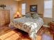 Large bedroom with wood flooring, a floral comforter, and ample natural light at 1898 Charleston Ln, Bartow, FL 33830
