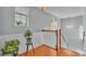 Upstairs hallway with wood floors and access to bedrooms at 2325 Bella Luna Cir, Lakeland, FL 33810
