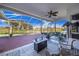 Screened patio with wooden deck overlooking a pond at 4402 Fairway Oaks Ct, Mulberry, FL 33860