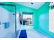 Bathroom with teal walls, shower, and window providing natural light at 4402 Fairway Oaks Ct, Mulberry, FL 33860