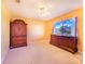 Bedroom with warm-toned walls, carpeted floor, and large window with a view at 4402 Fairway Oaks Ct, Mulberry, FL 33860