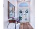 Bright entryway with tiled floors, console table, and mirror at 4402 Fairway Oaks Ct, Mulberry, FL 33860