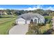 Single-story home with a two-car garage and landscaped yard at 4402 Fairway Oaks Ct, Mulberry, FL 33860