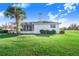 House exterior showcasing the backyard and landscaping at 4402 Fairway Oaks Ct, Mulberry, FL 33860