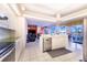 Open kitchen features island, stainless steel appliances, and views of living room at 4402 Fairway Oaks Ct, Mulberry, FL 33860